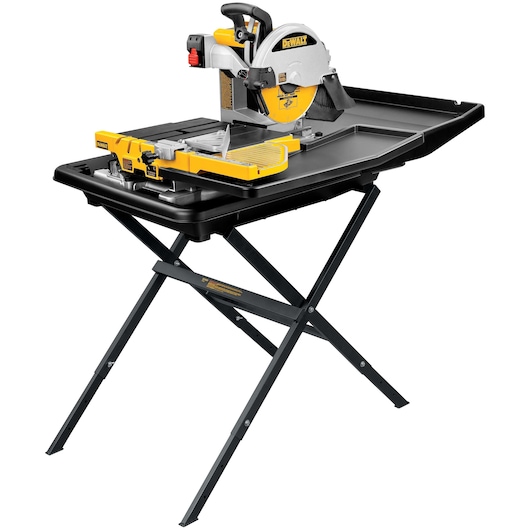 A DEWALT D24000S tile saw with a yellow and silver circular blade mounted on a black folding stand, featuring a sliding tray for accurate cutting.