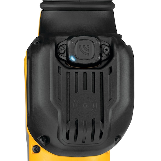 Close-up of a DEWALT tool showing a black protective cover with a button and LED indicator.