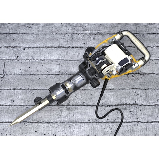 A DEWALT demolition hammer with a visible internal mechanism, shown on a concrete surface. The tool features a metal chisel tip, an electric motor, and a robust handle with a cable attached.