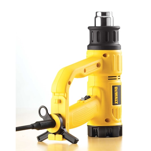 DEWALT heat gun, yellow, SKUs D26411, D26411-QS, for photography. Compact design with stand, cord attached.