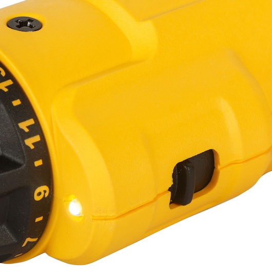 Close-up of a yellow DEWALT tool showing part of the dial, a screw, and a small LED light.