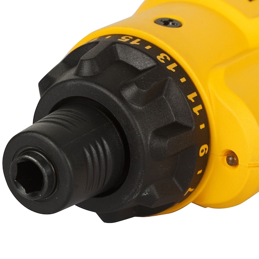 Partial close-up of a yellow DEWALT tool with a black nozzle, partly obscured by a shaded overlay.