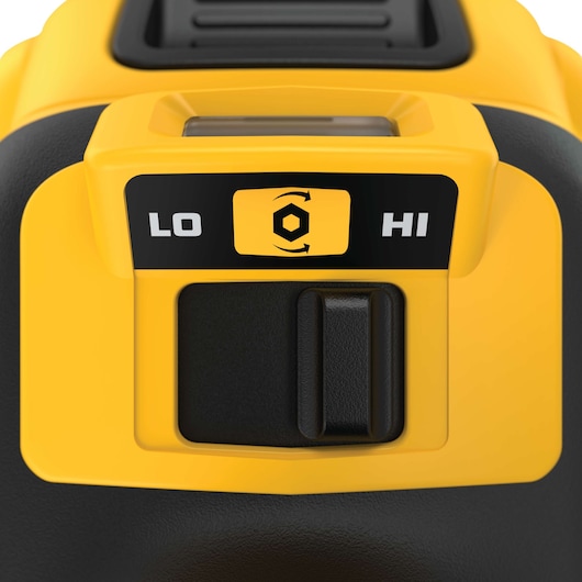 Close-up of a DEWALT tool control panel showing a switch with two speed options, labeled 'LO' for low and 'HI' for high, with a hex nut rotation symbol in the center. The panel features yellow and black colors.