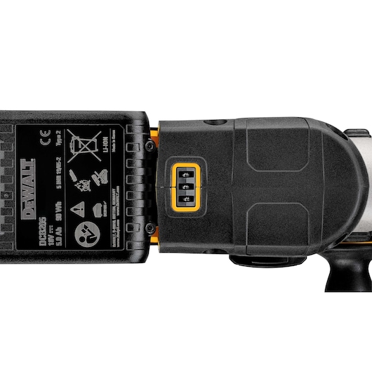 Close-up image of a DEWALT DCH273P2 cordless power tool, focusing on the battery compartment and control panel with visible warning labels and specifications.