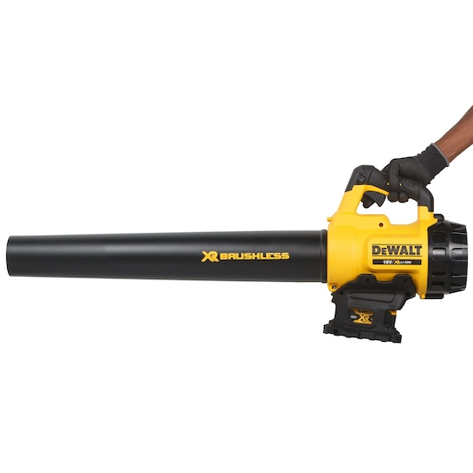 A DEWALT XR Brushless 18V cordless leaf blower held by a gloved hand, featuring a yellow and black design.