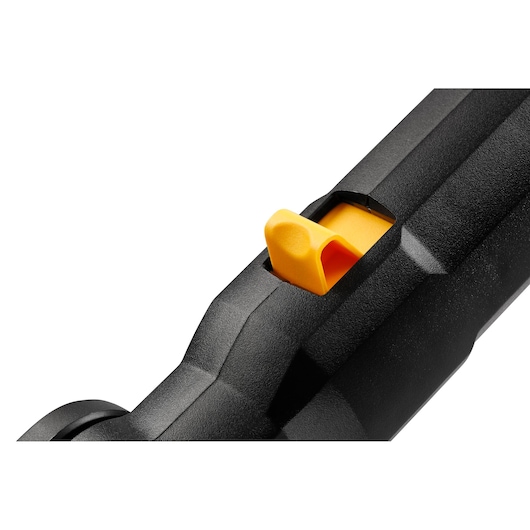 Close-up of a yellow switch on a black DEWALT tool handle.