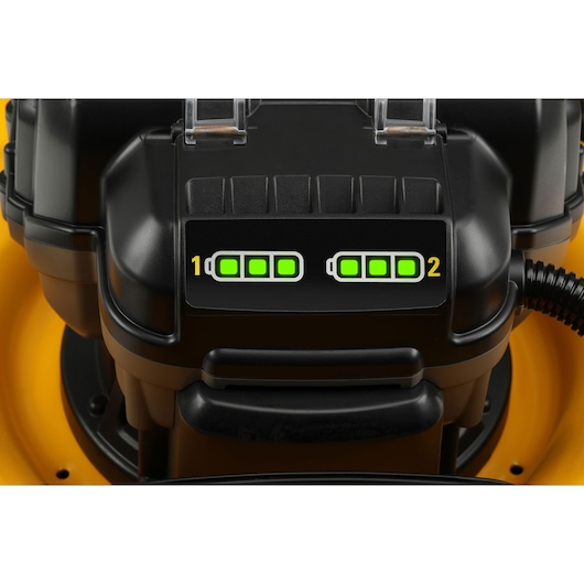 Close-up of DEWALT mower’s dual battery indicator, showing both batteries fully charged with green LED lights.