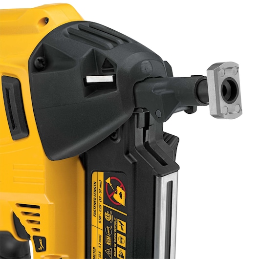Close-up of a DEWALT DCN8902 nailer, showing the tool’s front and warning labels on its side.