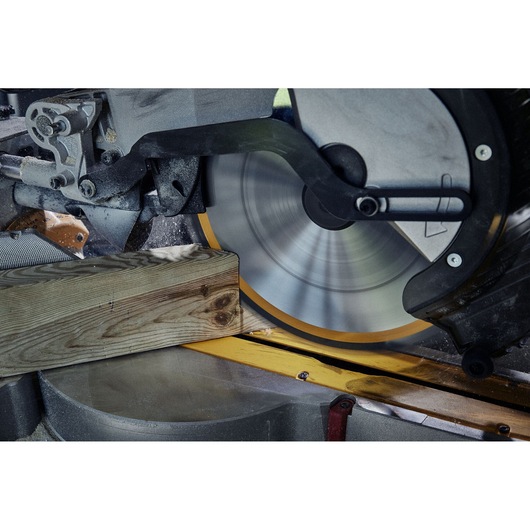 Close-up of a circular saw cutting a wooden plank with precision.