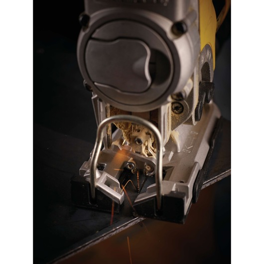 Close-up of a DEWALT jigsaw cutting metal, with sparks visible near the blade.