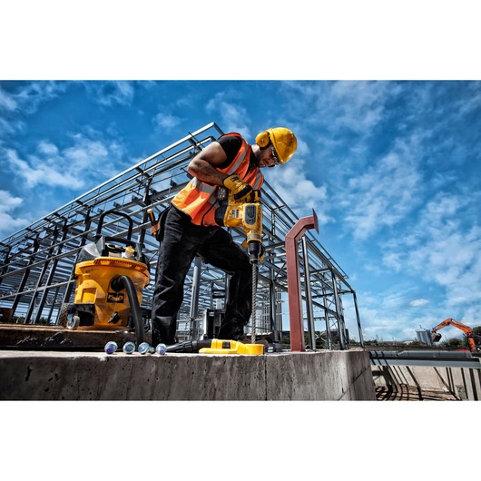 DEWALT DT60820, DT60820-QZ tools in use on construction site, worker with drill wearing safety gear, photography category.