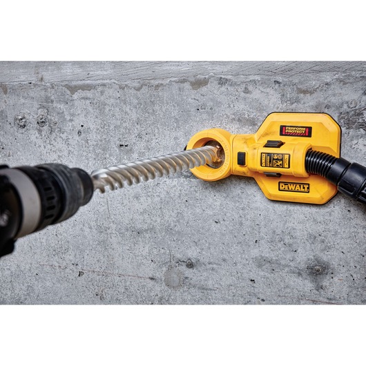 DEWALT DT60846 drill accessory in use on concrete wall with a spiral drill bit attached.