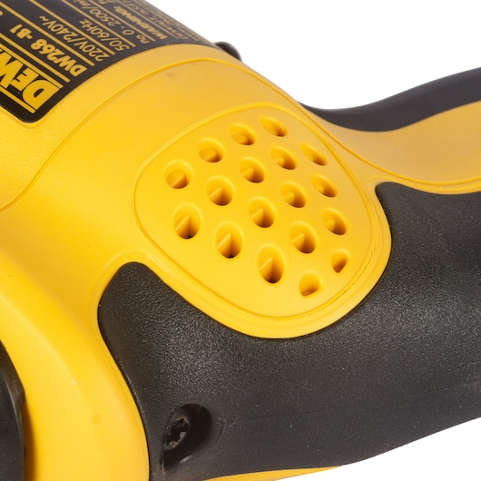 Close-up of a yellow and black DEWALT DW268 power tool with vent holes and textured grip.