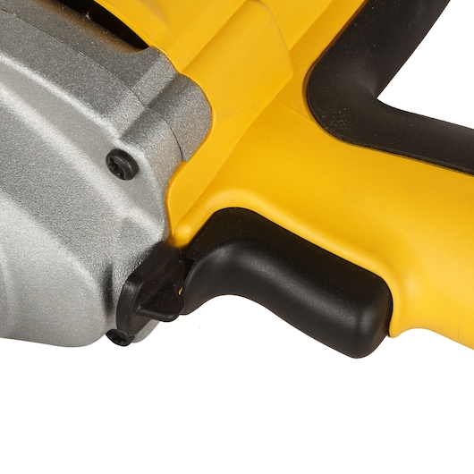 Close-up of the handle and trigger of a yellow DEWALT power tool with a metal casing.