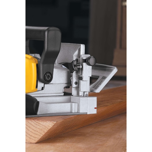 DEWALT DW682K-QS, DW682K biscuit joiner used on wood. Photography category product close-up.