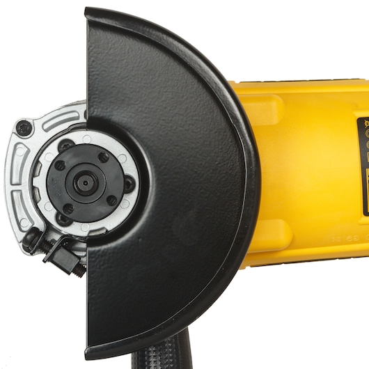 Close-up of a DEWALT DWE493 angle grinder with a protective guard and yellow body.