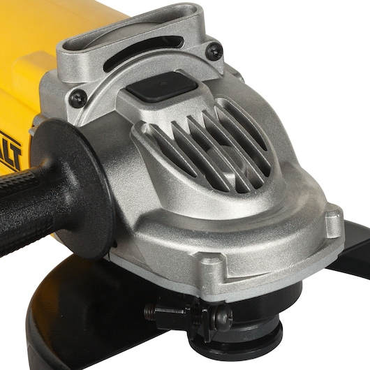 Close-up of a DEWALT DWE493 angle grinder with a side handle and metal protective casing.