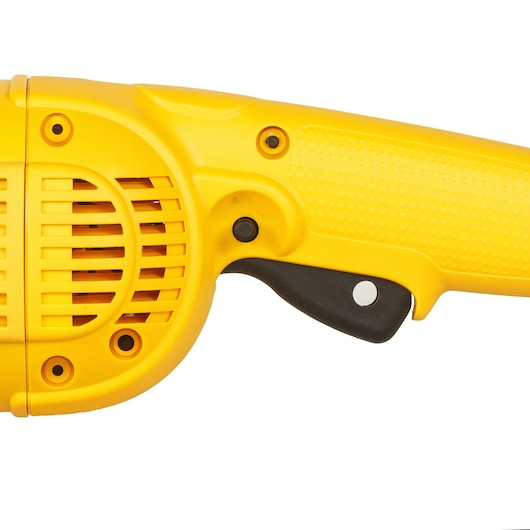 Close-up of a yellow DEWALT power tool handle and trigger with vented housing and textured grip.