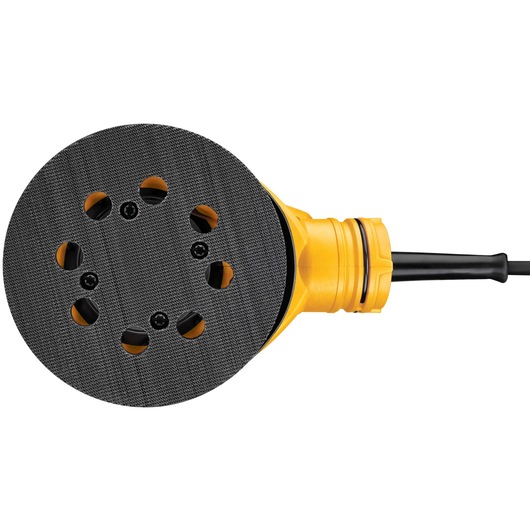 Close-up view of a DEWALT DWE6423 random orbit sander showing the round sanding pad with multiple ventilation holes and a yellow body.