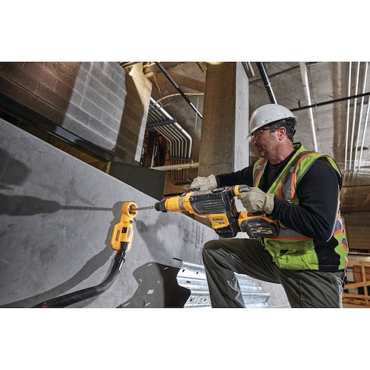 DEWALT DWH050, DWH050K, DWH050-XJ attachment in use on a drill in construction setting.