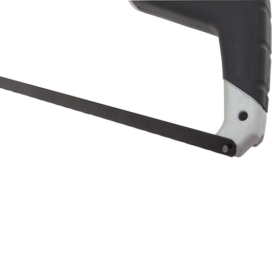 Close-up of a DEWALT hacksaw with a metal frame and fine blade, showing part of its ergonomic handle.