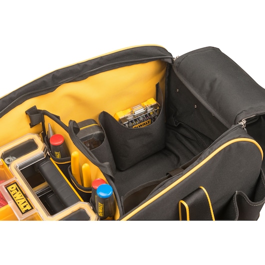 DEWALT tool bag interior showing organized compartments and tools, with yellow and black design details.